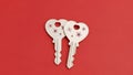 Two Heart-Shaped Keys on Red Background Royalty Free Stock Photo