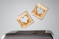 Two Heart shaped on roasted toasted bread in a toaster. Breakfast preparation on Valentine`s Day. symbol sign of love. Concept.