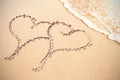 Two heart shapes inscribe on sand