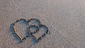 Two hearts drawn on brown sand of paradise beach Royalty Free Stock Photo