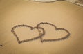 Two hearts drawn on sand beach Royalty Free Stock Photo