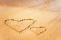 Two hearts are drawn on the sand by the sea.Valentine`s day background Royalty Free Stock Photo