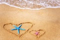 Two hearts are drawn on the sand by the sea.Valentine`s day background Royalty Free Stock Photo