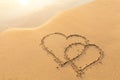 Two hearts drawn in the sand, symbol of love, honeymoon Royalty Free Stock Photo