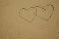 Two hearts is drawn on the sea beach sand. Royalty Free Stock Photo