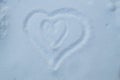 Two hearts drawn on snow, symbol of pregnancy, love