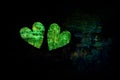 Two hearts in green on a black background. Creative background Royalty Free Stock Photo