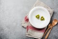 Two hearts from kiwi on a white ceramic plate on a gray concrete or stone background. Postcard for Valentine`s Day. Selective Royalty Free Stock Photo