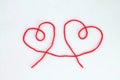 Two hearts made of red thread on a white background. Royalty Free Stock Photo
