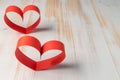 Two hearts made of ribbon on wooden background. Royalty Free Stock Photo