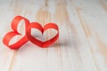 Two hearts made of ribbon on wooden background. Royalty Free Stock Photo