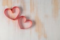 Two hearts made of ribbon on wooden background. Royalty Free Stock Photo