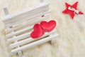 Two hearts on a miniature wooden bench