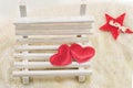 Two hearts on a miniature wooden bench