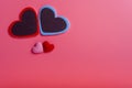 Two hearts on a pink background in the upper left corner and two small hearts. The concept of Valentine`s day Royalty Free Stock Photo