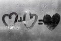 Two hearts with plus sing and equality sign on window in Rainy weather , valentine`s day Royalty Free Stock Photo