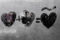 Two hearts with plus sing and equality sign on window in Rainy weather , valentine`s day Royalty Free Stock Photo