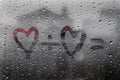 Two hearts with plus sing and equality sign on window in Rainy weather Royalty Free Stock Photo