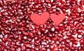 Two hearts on pomegranate berries. Berry background