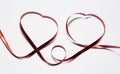 Two hearts of red ribbon on white background Royalty Free Stock Photo