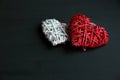 Two hearts red and white on black wooden table. Valentines, spring background. Mock up with copyspace. happy Mothers day, romantic