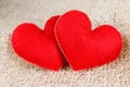 Two hearts symbol of love on burlap background. Royalty Free Stock Photo