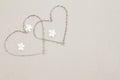 Two hearts with white flowers on the beach surface background Royalty Free Stock Photo