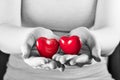 Two hearts in woman hands. Love, care, health, protection. Royalty Free Stock Photo