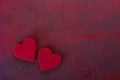 Two hearts on the wooden board painted in dark-red with copy space for text. Flat lay.  Valentine`s day background Royalty Free Stock Photo