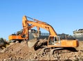 Two heavy excavators at work  during urban redevelopment works. Royalty Free Stock Photo