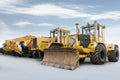 Two heavy wheeled tractor one excavator and other construction machinery isolated on bright