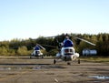 Two helicopters are parked