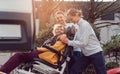 Two helpers picking up disabled senior woman for transport Royalty Free Stock Photo