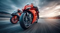 Two high-performance motorcycles race neck and neck on a track, showcasing speed and competition under a dramatic sky. Royalty Free Stock Photo