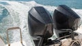 Two high-powered engines mounted on the back of the speedboat Royalty Free Stock Photo