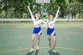 Two high school cheerleaders cheer on basketball field Royalty Free Stock Photo