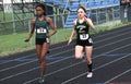 Two high school girls participate in a track meet Royalty Free Stock Photo