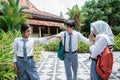 two high school girls quarreled with each other with hand gestures and a handsome male student separated