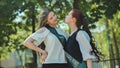 Two high school senior girls playfully sort of kissing.