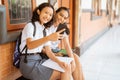 two high school students smiling while taking selfies outside Royalty Free Stock Photo