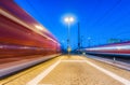 Two high speed trains in motion on the railway station at night Royalty Free Stock Photo