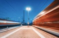 Two high speed trains in motion on the railway station at night Royalty Free Stock Photo