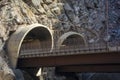 Two Highway Tunnel Entrances cut into a Mountainside Royalty Free Stock Photo