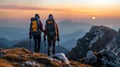 Two Hikers Admiring the Sunset at a Mountain Peak