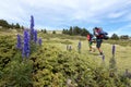 Two hikers and flowers