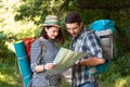 Two Hikers looking Map staying on Forest Trail Royalty Free Stock Photo