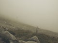 Two hikers on the mountain with deep dense fog