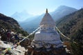 Two hikers passing white buddhist stupa on the Everest trek in Himalayas mountains, Nepal Royalty Free Stock Photo