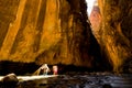 Two hikers in a sunbeam at Wall Street, in The Narrows hike at Zion National Park. Royalty Free Stock Photo