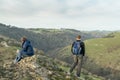 Two hikers take in the view at the summit of Thorpe Cloud, Peak District, Derbyshire